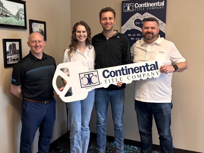 Sam and Sarah on closing day, Overland Park, KS, with Luke Wright and lender Tim Munyan