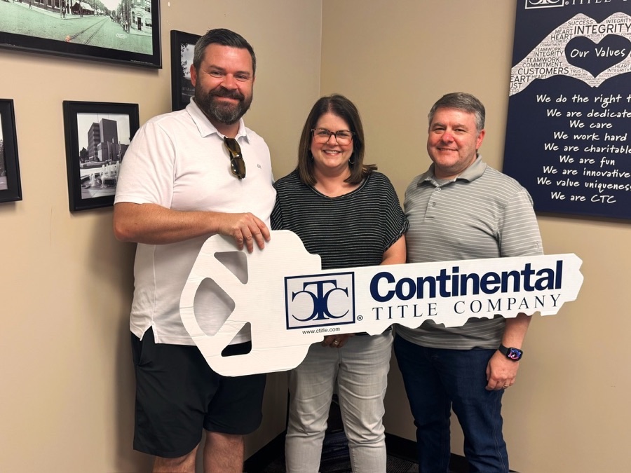 Jon and Rachel on closing day, Olathe, KS, with Luke Wright