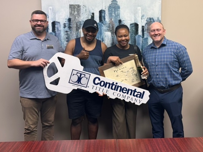 Olu and Abi on closing day, Olathe, KS, with Luke Wright and lender Tim Munyan