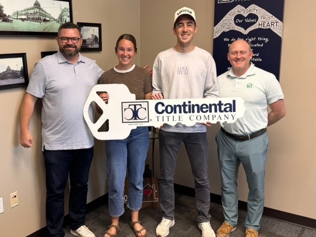 Savannah and Jake on closing day, Lenexa, KS, with Luke Wright and lender Tim Munyan